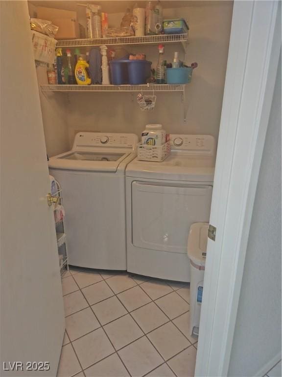 laundry room featuring laundry area, light tile patterned floors, and washer and dryer