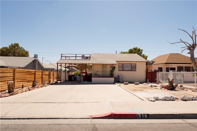 view of front of property featuring a carport