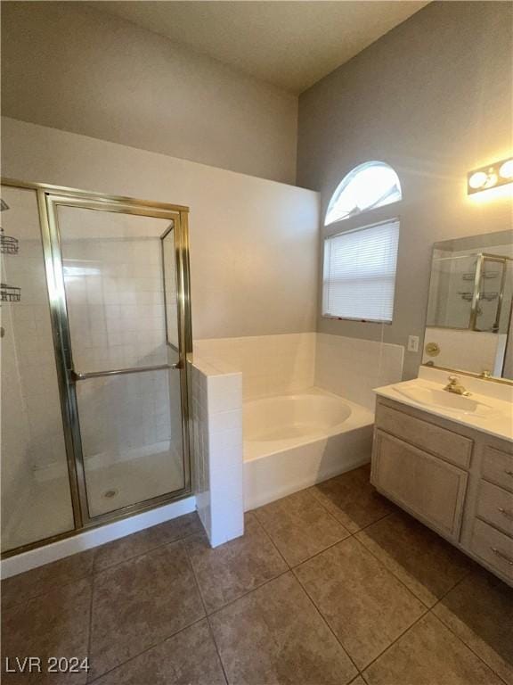 bathroom featuring tile patterned flooring, vanity, and plus walk in shower