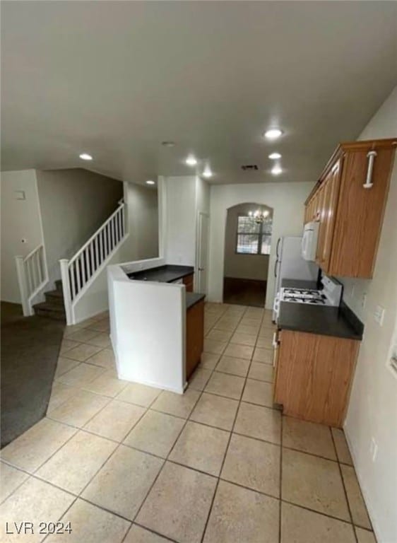 kitchen featuring stove and light tile patterned floors