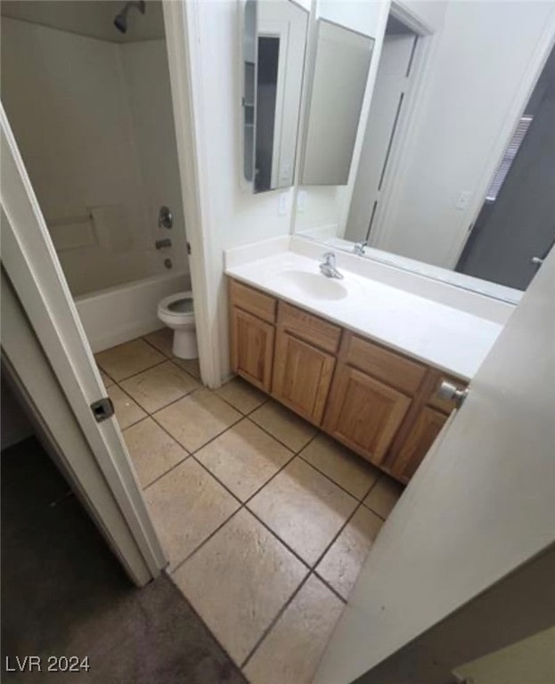 full bathroom with tile patterned floors, washtub / shower combination, vanity, and toilet