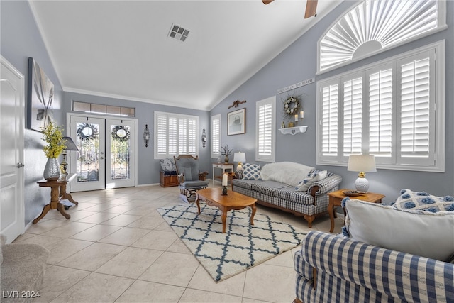 tiled living room with ceiling fan, crown molding, french doors, and lofted ceiling