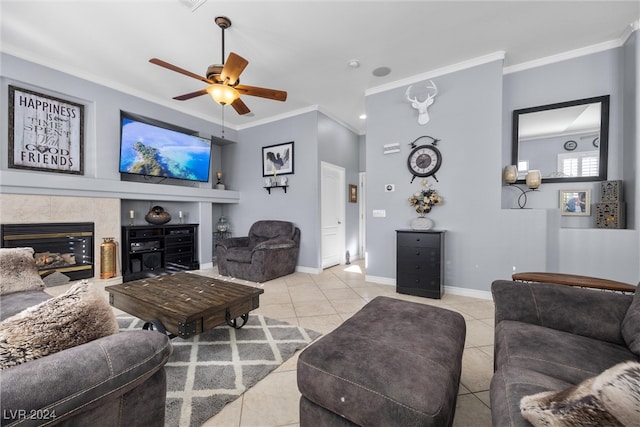 living room featuring ceiling fan, a high end fireplace, light tile patterned floors, and crown molding