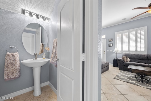 bathroom with ceiling fan and tile patterned flooring