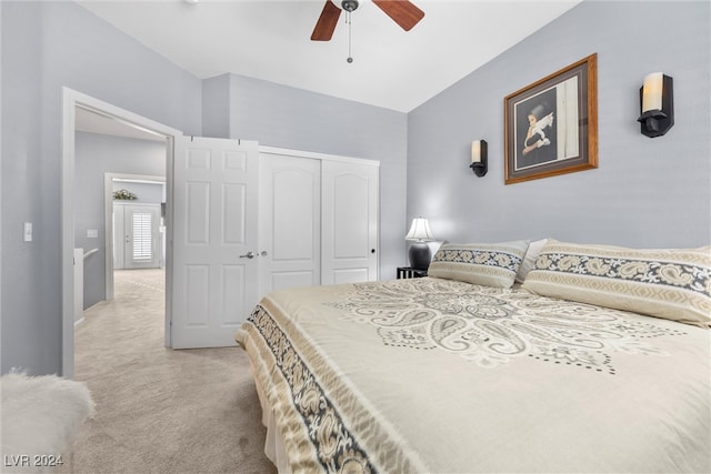 carpeted bedroom with ceiling fan and a closet