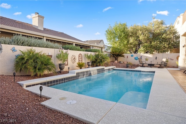 view of swimming pool featuring pool water feature