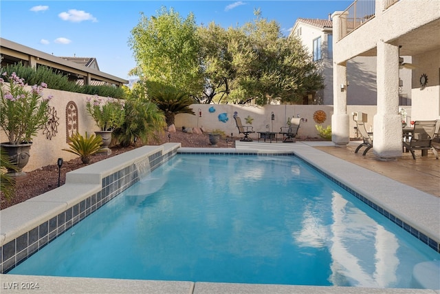 view of pool with pool water feature and a patio area