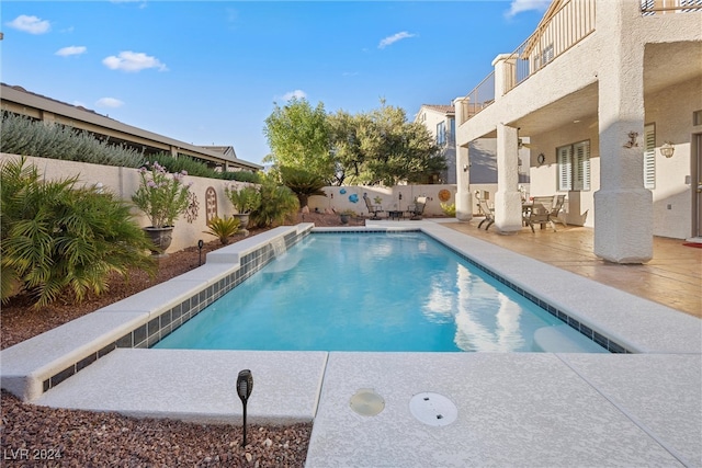 view of swimming pool with a patio area