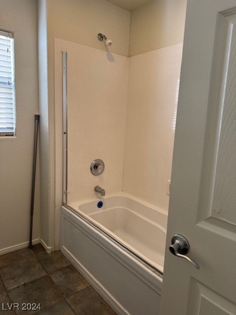 bathroom featuring tile patterned flooring and  shower combination