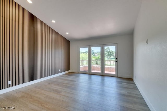 unfurnished room with recessed lighting, light wood-style flooring, and baseboards