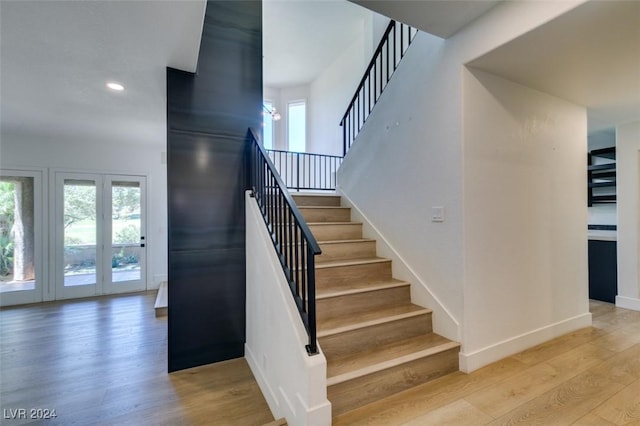 stairway featuring recessed lighting, baseboards, and wood finished floors