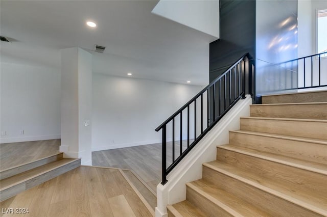 stairway with visible vents, recessed lighting, baseboards, and wood finished floors