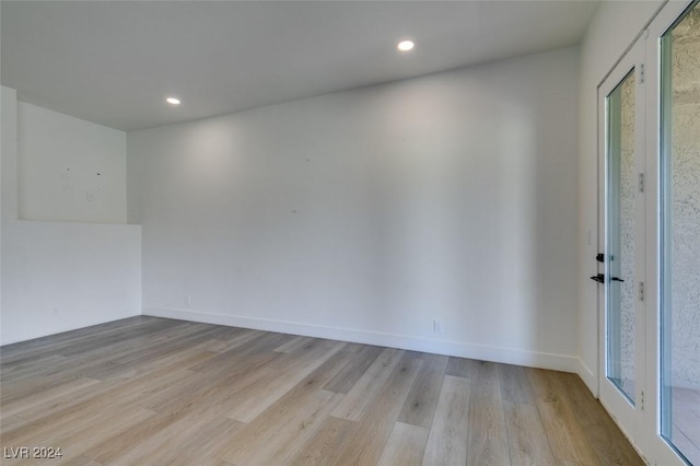 spare room with recessed lighting, baseboards, and light wood-style floors