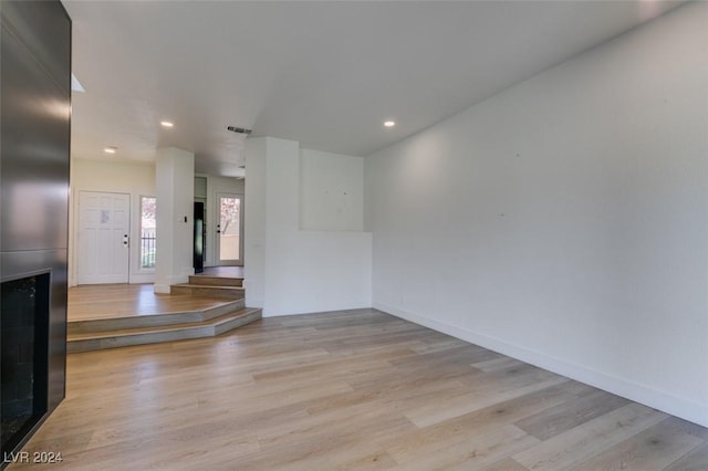 empty room featuring visible vents, recessed lighting, baseboards, and wood finished floors