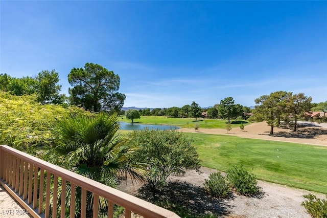 view of property's community featuring a water view and a lawn