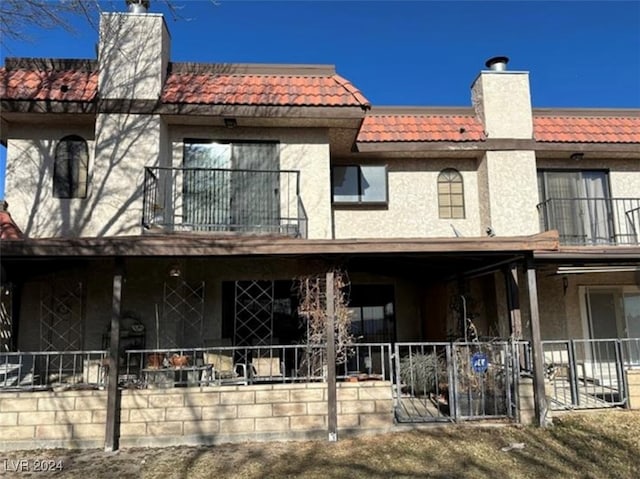 back of property featuring a balcony