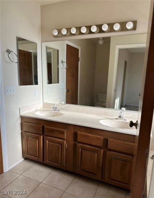 bathroom featuring tile patterned flooring and double vanity