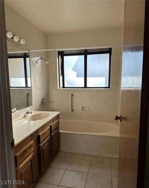 bathroom featuring tile patterned floors, vanity, and tiled shower / bath