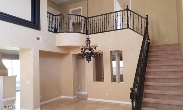1700 Ravanusa Dr, Henderson, NV 89052 - stairway with a high ceiling, a chandelier, baseboards, and visible vents