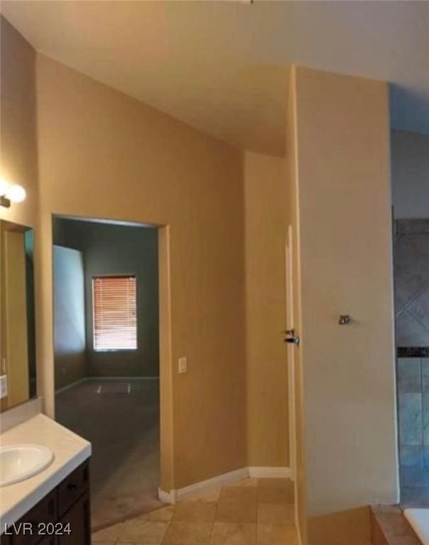 1700 Ravanusa Dr, Henderson, NV 89052 - full bath with a bath, tile patterned flooring, vaulted ceiling, vanity, and baseboards