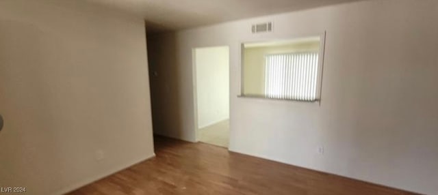 empty room with hardwood / wood-style floors