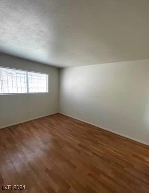 empty room featuring wood-type flooring