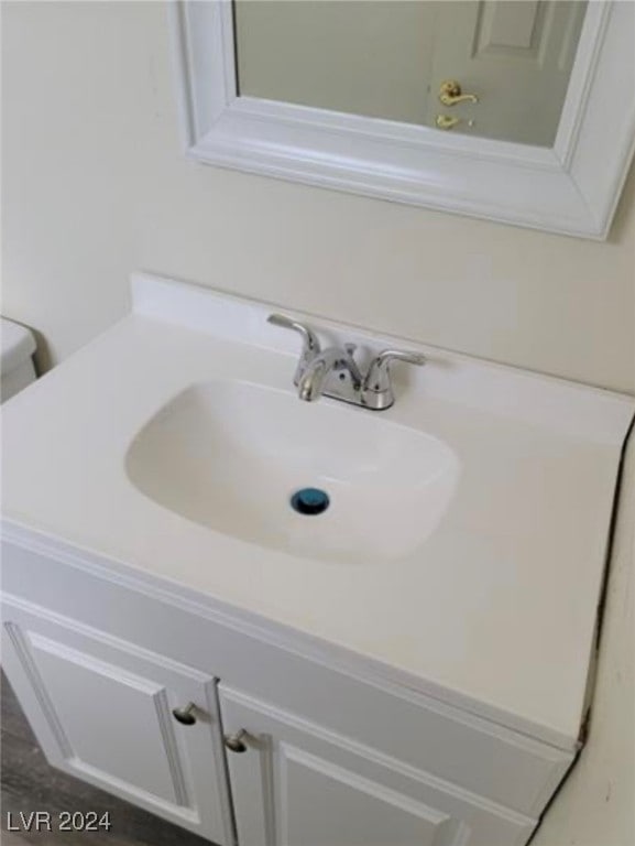 bathroom with toilet and vanity