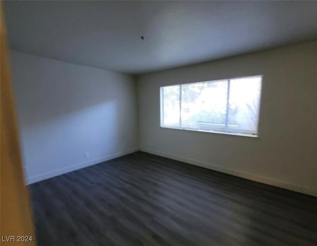 spare room featuring dark hardwood / wood-style floors