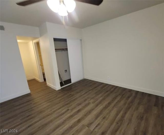 unfurnished bedroom with ceiling fan, a closet, and dark hardwood / wood-style flooring