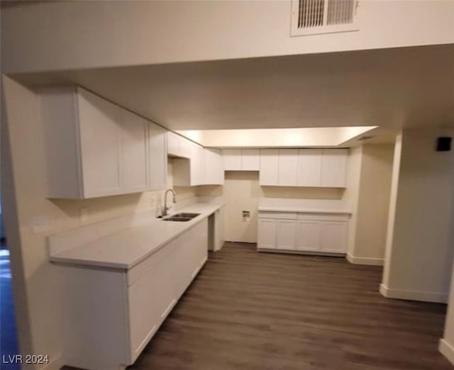 kitchen featuring sink, white cabinets, and dark hardwood / wood-style floors