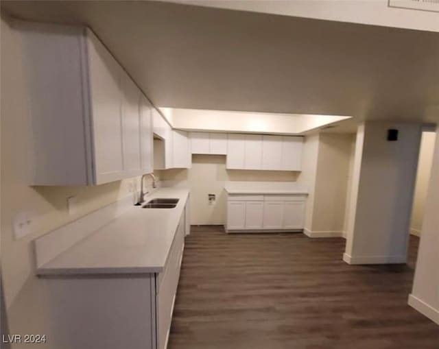 kitchen with sink, dark hardwood / wood-style flooring, and white cabinetry