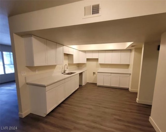 kitchen with sink, white cabinets, and dark hardwood / wood-style flooring