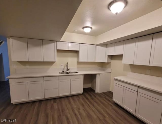 kitchen featuring sink, white cabinetry, and dark wood-type flooring