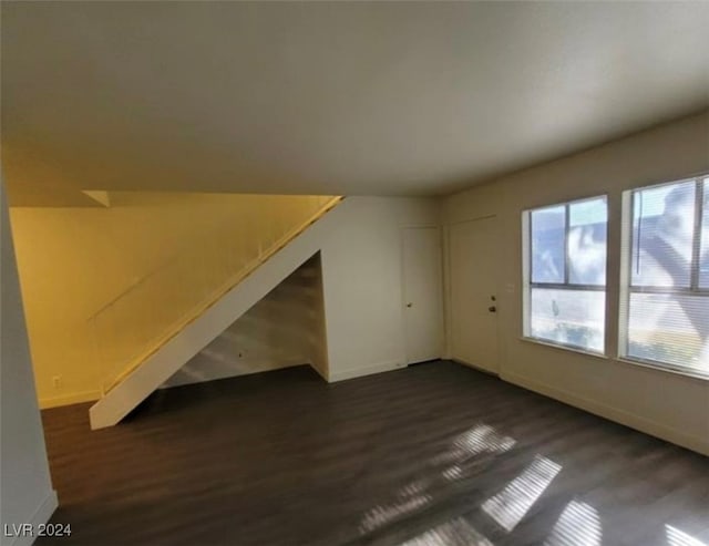 bonus room with dark hardwood / wood-style flooring