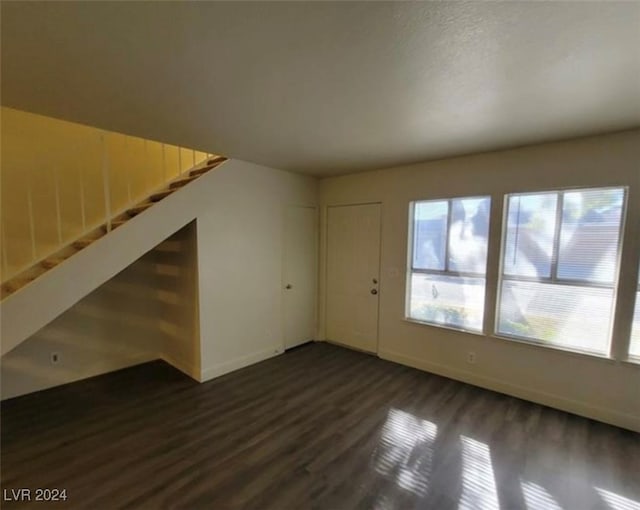 additional living space featuring dark hardwood / wood-style floors