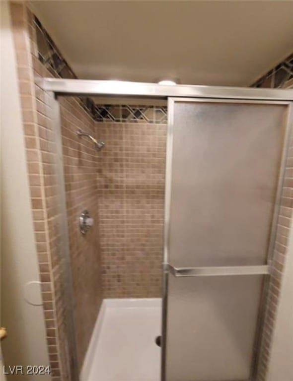 bathroom with a shower with shower door