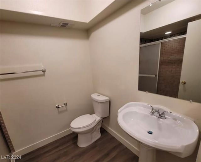 bathroom with sink, toilet, and hardwood / wood-style flooring