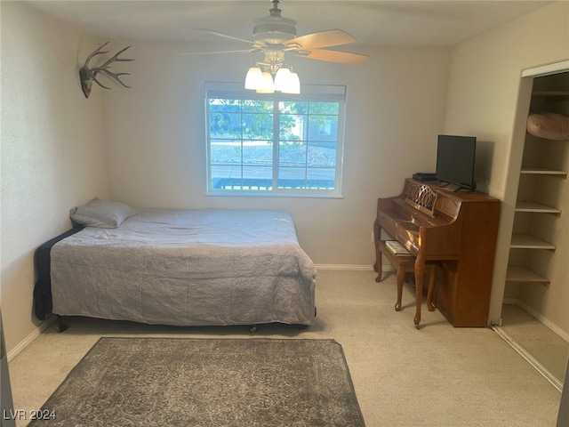 bedroom with a ceiling fan, baseboards, and carpet flooring