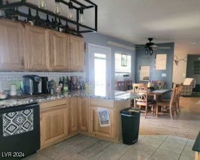 kitchen featuring ceiling fan, light tile patterned floors, and black dishwasher