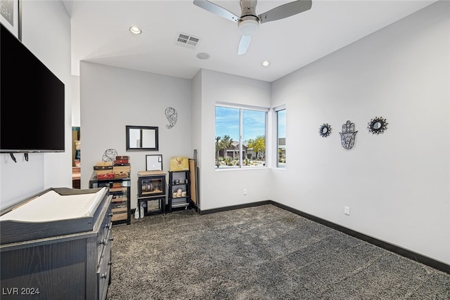 carpeted home office with ceiling fan