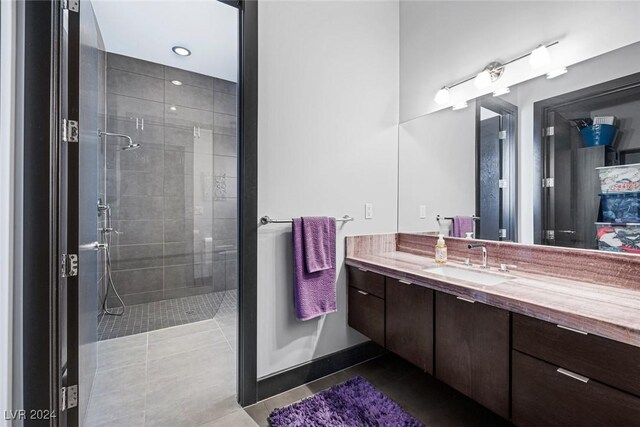 bathroom with tile patterned floors, vanity, and a shower with shower door