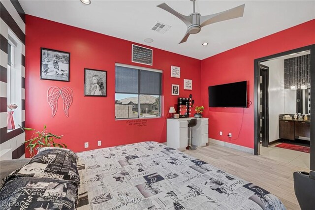 bedroom featuring ceiling fan, hardwood / wood-style flooring, and ensuite bathroom