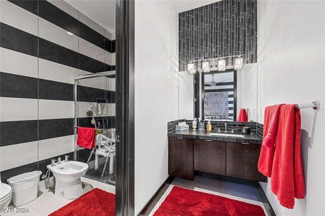 bathroom with a bidet, a shower with shower door, tile patterned flooring, vanity, and toilet