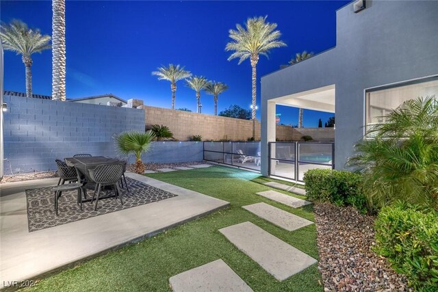 view of yard with a fenced in pool and a patio