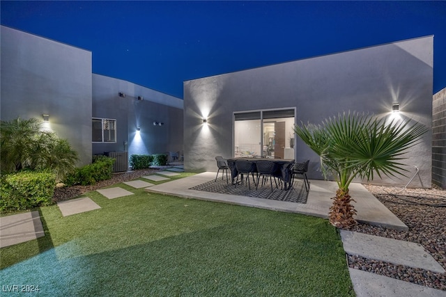 yard at twilight featuring a patio