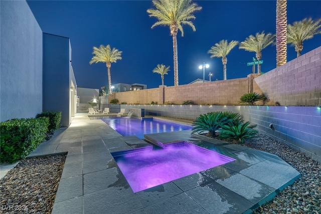 pool at night with a patio