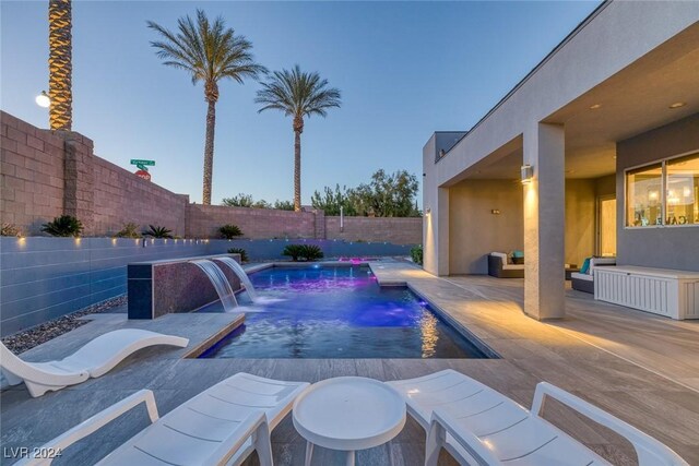 view of swimming pool featuring pool water feature and a patio