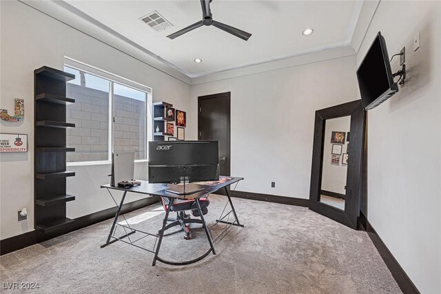 carpeted office featuring ceiling fan and ornamental molding