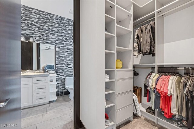 walk in closet with light tile patterned flooring