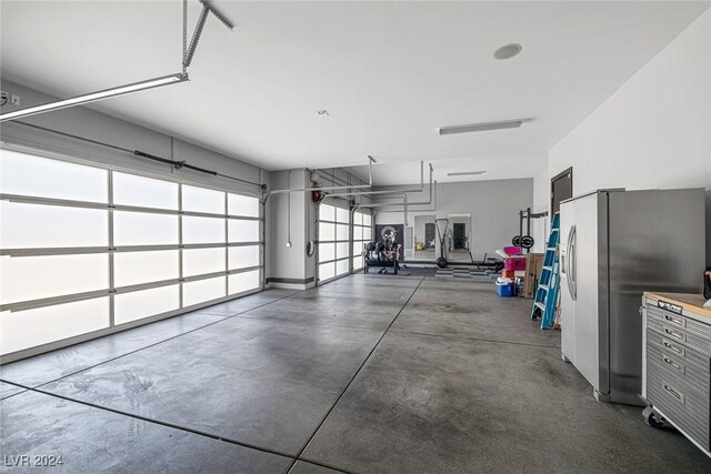 garage with stainless steel refrigerator with ice dispenser